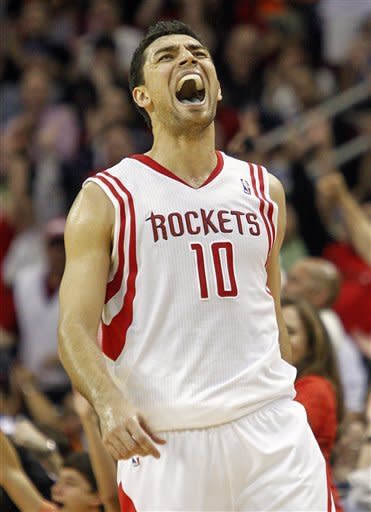 Houston Rockets shooting guard Carlos Delfino (10) lets out of yell after scoring a 3-point shot at the buzzer to end the first half of an NBA basketball game against the Cleveland Cavaliers, Friday, March 22, 2013, in Houston. (AP Photo/Bob Levey)