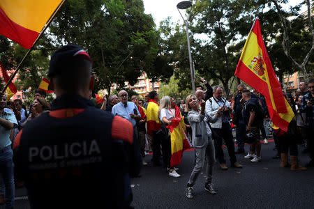 A protester against a banned referendum on independence in Catalonia gestures at pro-independence supporters (not pictured) during a demonstration in Barcelona, Spain, September 22, 2017. REUTERS/Susana Vera