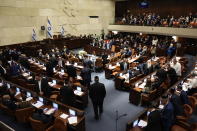 Israeli Knesset members listen during the swearing-in ceremony for Israeli lawmakers at the Knesset, Israel's parliament, in Jerusalem, Tuesday, Nov. 15, 2022. Israeli lawmakers were sworn in at the Knesset, on Tuesday, following national elections earlier this month. (Abir Sultan/Pool Photo via AP)