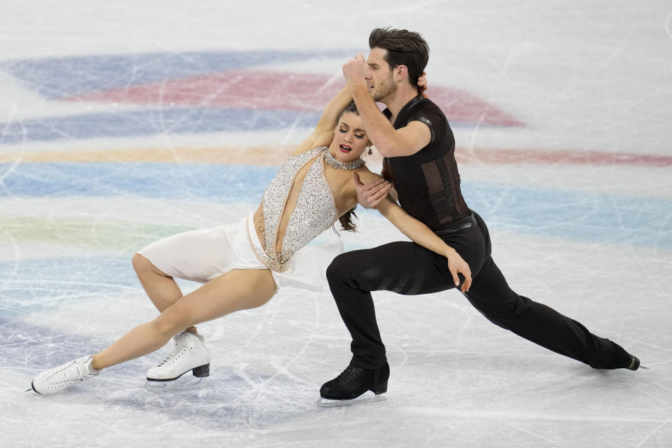 Laurence Fournier Beaudry and Nikolaj Soerensen, of Canada, perform their routine in the ice dance competition during the figure skating at the 2022 Winter Olympics, Monday, Feb. 14, 2022, in Beijing. (AP Photo/Natacha Pisarenko)