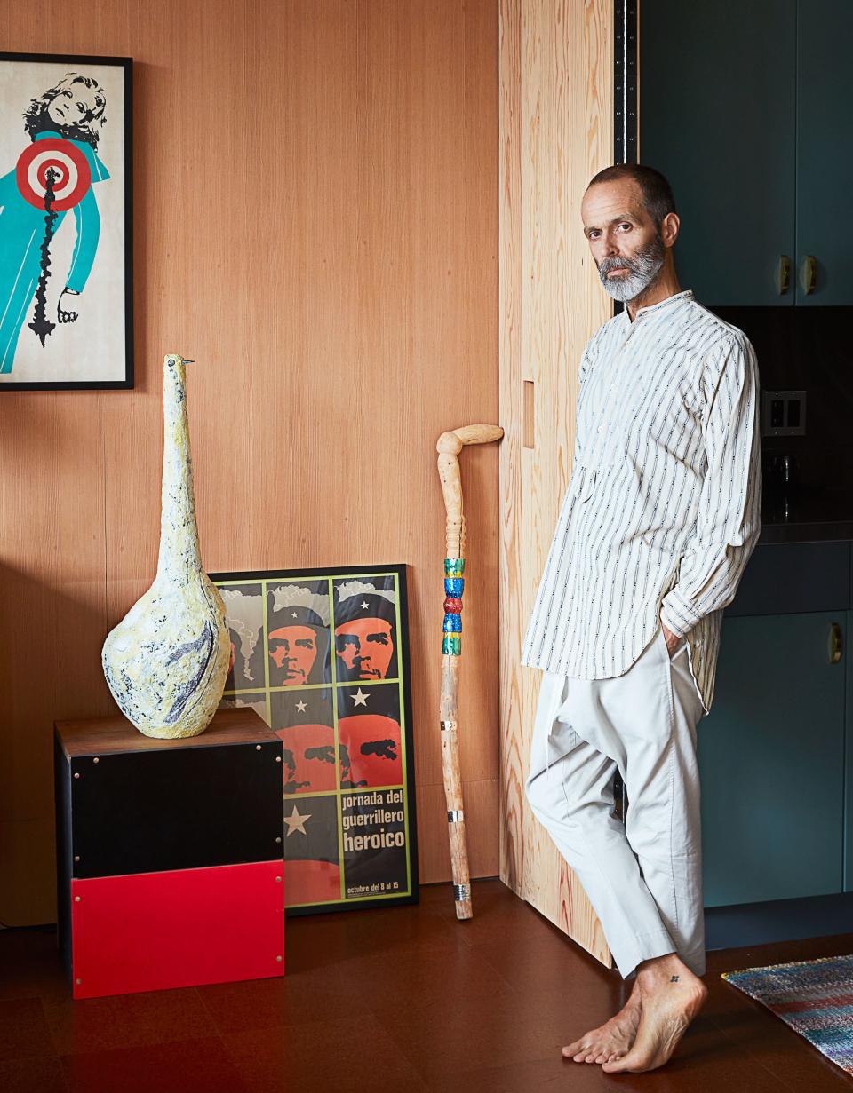 Alonso in his dining room. Livia Gorka ceramic bird sculpture.