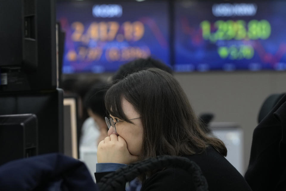 A currency trader watches monitors at the foreign exchange dealing room of the KEB Hana Bank headquarters in Seoul, South Korea, Tuesday, March 28, 2023. Asian shares were mostly higher on Tuesday as investors got some relief from worries over troubled U.S. banks with a planned takeover of failed Silicon Valley Bank.(AP Photo/Ahn Young-joon)