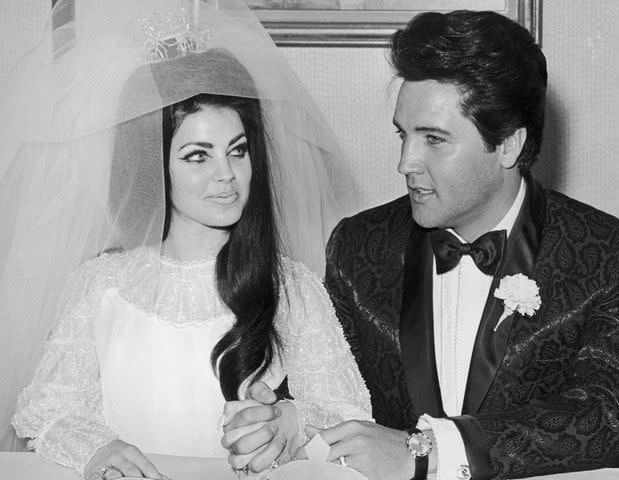 <p>Hulton Archive/Getty</p> Elvis Presley and Priscilla Ann Beaulieu following their wedding on May 1, 1967.