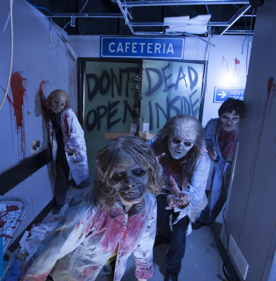 This image provided by Universal Orlando Resort shows actors portraying zombies at an attraction themed on the AMC show “The Walking Dead” at Universal’s Halloween Horror Nights in Orlando, Fla. The theme park also has attractions inspired by the video game and movie “Silent Hill,” Alice Cooper’s concept album “Welcome to My Nightmare” and a House of Horrors featuring classic monsters from Universal films. (AP Photo/Universal Orlando Resort, Kevin Kolczynski)