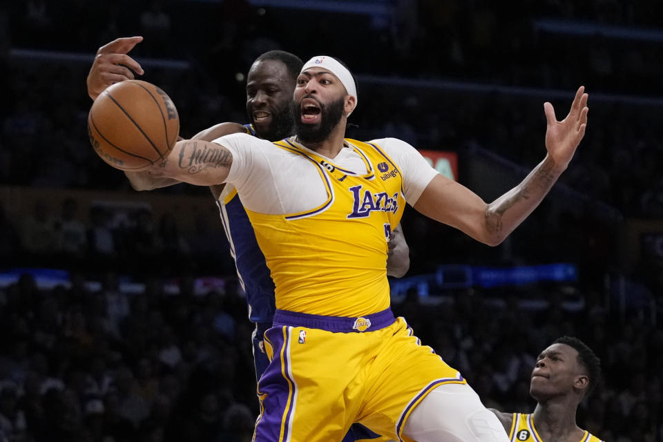 Los Angeles Lakers forward Anthony Davis (3) vies for a rebound against Golden State Warriors forward Draymond Green during the first half in Game 6 of an NBA basketball Western Conference semifinal series Friday, May 12, 2023, in Los Angeles. (AP Photo/Ashley Landis)