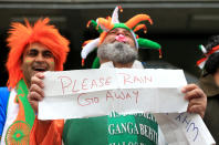 Indian fans shelter from the rain during the ICC Champions Trophy Final at Edgbaston, Birmingham.