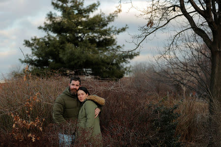 Jenny Ostrom, 37, a director of photography and her husband Chad Ostrom, 37, a director, stand in McCarren Park, near their home in the Brooklyn borough of New York, U.S., February 8, 2018. "We met the first day of college in the middle of the heartland, Kansas. My friends and I thought it noble to help the arriving freshman girl students move into the dorms. There was Jenny, unpacking boxes with her family and in classic, comedy double-take action I walked by her room, stopped, and walked right back to it. Through three states, long-distance dating, high times, low moments and 19 years later, we now share a home, a little girl and a life," said Chad. REUTERS/Lucas Jackson