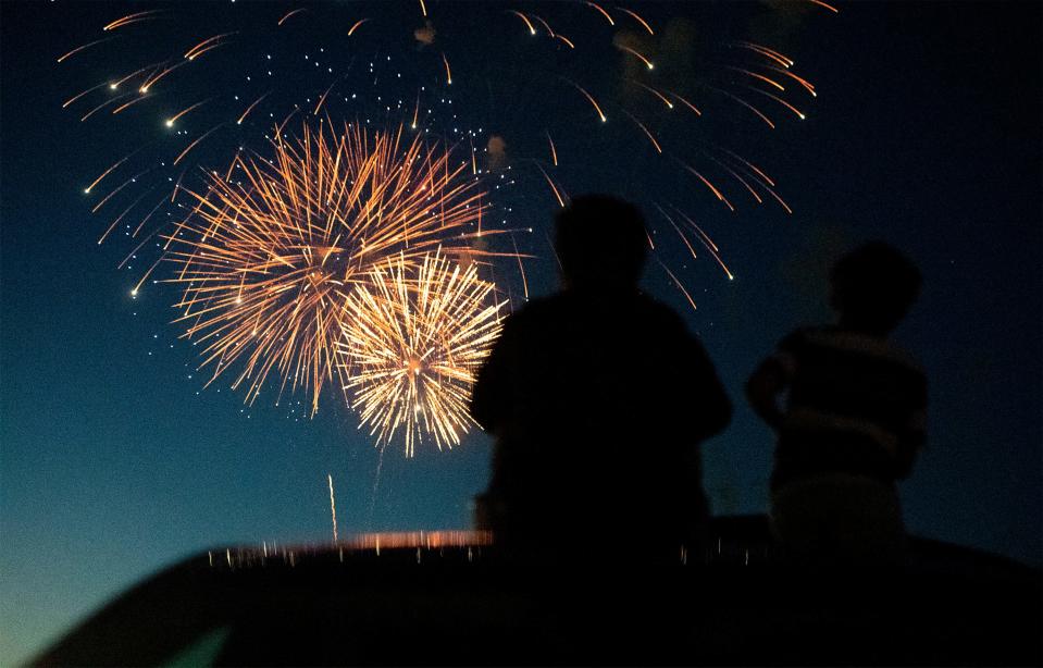 People sit on their car during the fireworks show at The Ranch events complex in Loveland on July 4, 2021. After two years of joining forces with other municipalities to host fireworks at The Ranch, the city of Fort Collins will host its own show on Saturday.