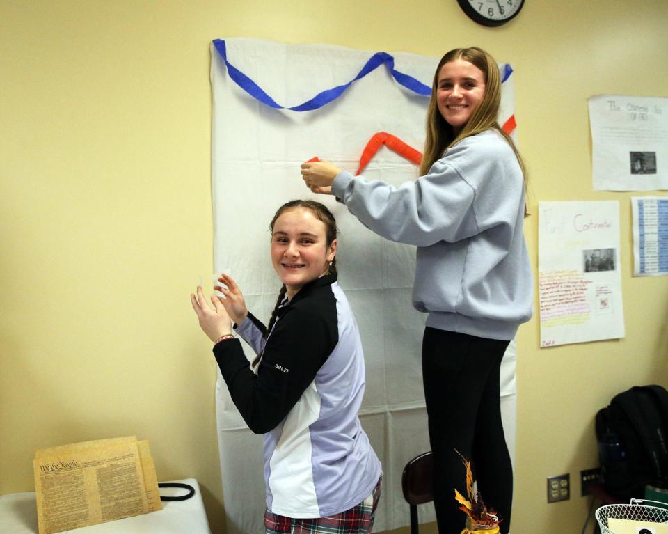 Middle School of the Kennebunks eighth-graders Teagan Hanson, left, and Charlotte Johnson help decorate the Redcoats and Revolutions Grill and Tavern on Thursday, Feb 2.
