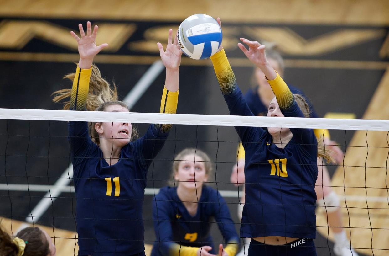 Pewamo-Westphalia's Saige Martin, right, blocks against Monroe St. Mary Catholic Central as Taylor Smith, left, and Marianna Hagen watch, Tuesday, Nov. 15, 2022, at Dansville High School.