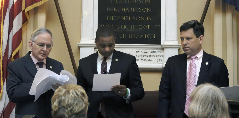 Senate Minority Leader Tommy Norment, R-James City, left, Lt. Gov. Justin Fairfax, center and Sen. Scott Surovell, D-Fairfax, right, confer as Surovell's bill relating to control of firearms by localities, one of a number of gun-related bill, is debated in the Senate, Thursday, Jan. 16, 2020, at the Capitol in Richmond, Va. (Bob Brown/Richmond Times-Dispatch via AP)