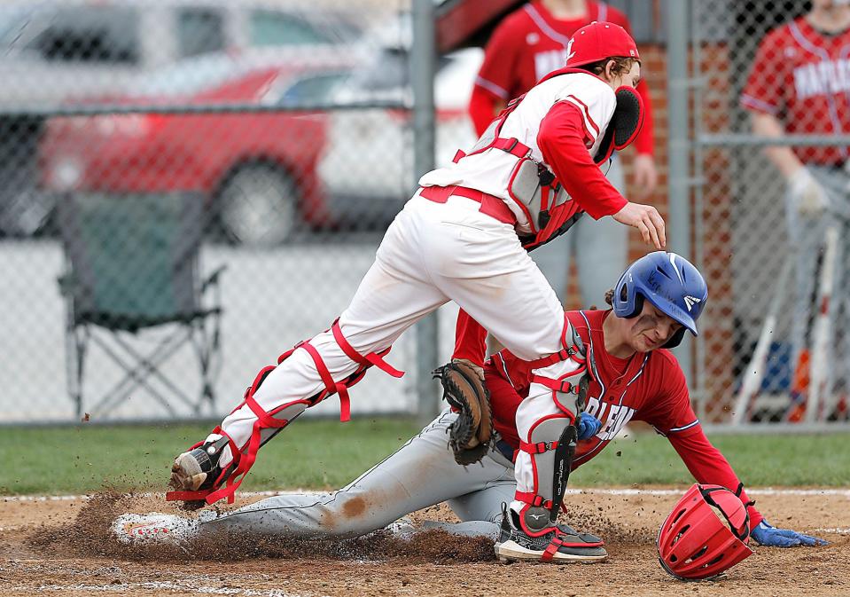 Loudonville's Aiden Wolford (1) tags out Mapleton's Lane Dreibelbis at home plate Thursday, April 6, 2023, at Loudonville High School.