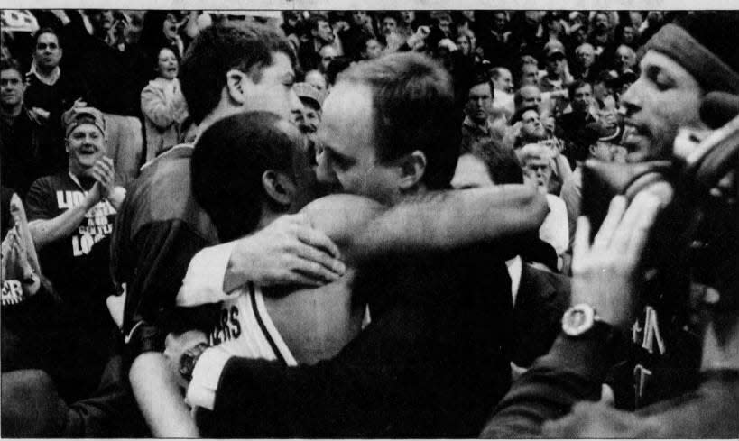 Xavier head coach Thad Matta hugs Lionel Chalmers after Xavier beat No. 10 UC in the Crosstown Shootout on Feb. 3, 2004.