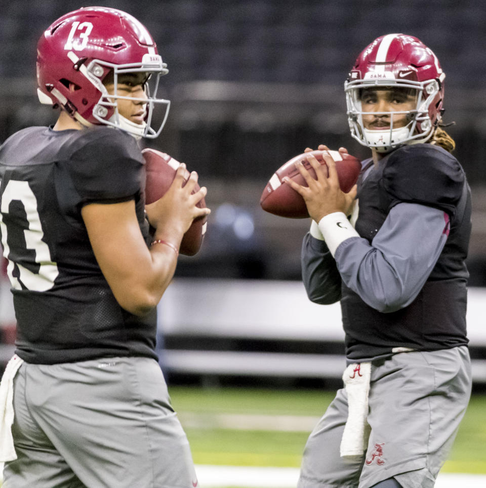 FILE - Alabama quarterbacks Tua Tagovailoa, left, and Jalen Hurts run a drill together at NCAA college football practice for the Sugar Bowl against Clemson, Thursday, Dec. 28, 2017, in New Orleans, La. The QBs who go head-to-head for the first time in the NFL when the Miami Dolphins visit the Philadelphia Eagles on Sunday, will forever be linked by their tenures under coach Nick Saban at Alabama. (Vasha Hunt/The Birmingham News via AP, File)