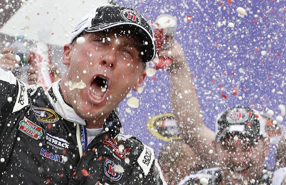 Kevin Harvick celebrates in Victory Lane with his crew after winning the NASCAR Sprint Cup Series auto race Sunday, March 2, 2014, in Avondale, Ariz. (AP Photo/Ross D. Franklin)