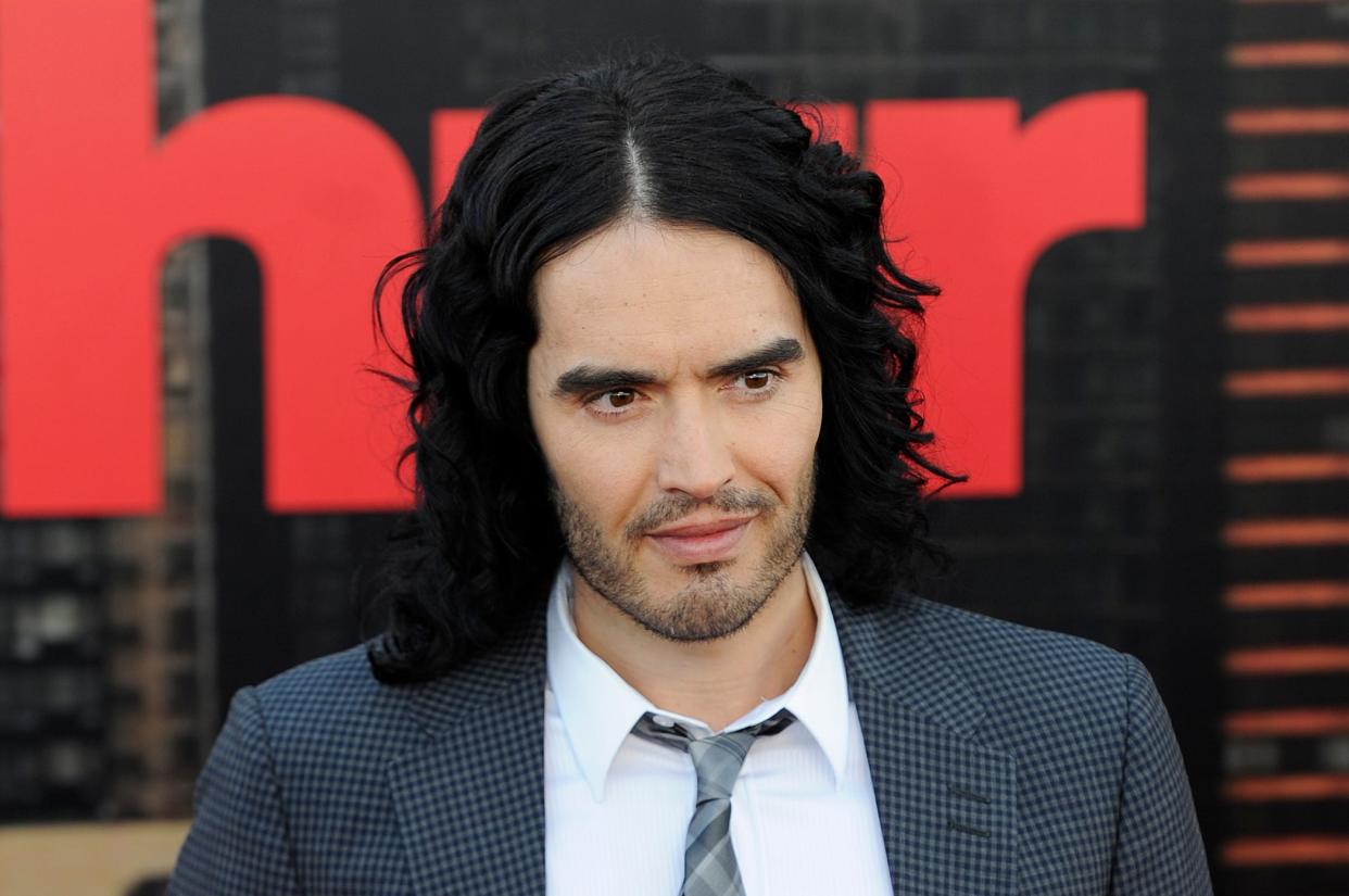 Russell Brand on the red carpet at the movie premeire of Arthur in 2011.