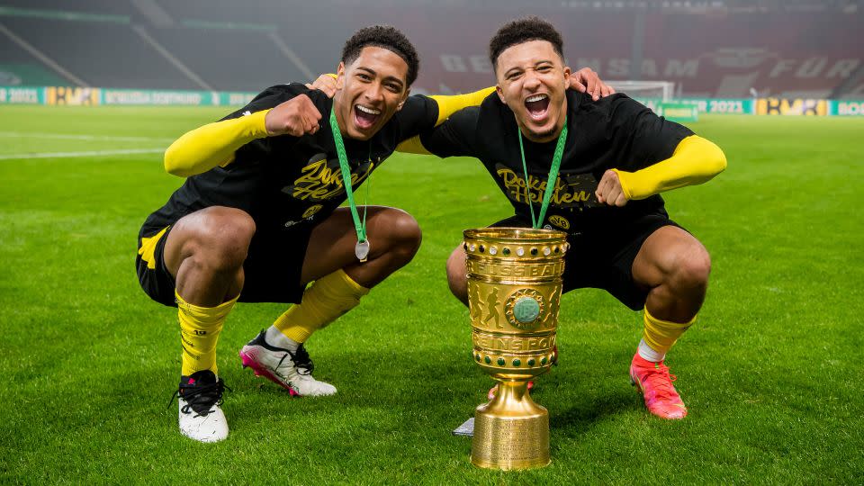 Bellingham and Sancho celebrate after winning the German Cup against RB Leipzig at the Olympic Stadium on May 13, 2021, in Berlin. - Alexandre Simoes/Borussia Dortmund/Getty Images