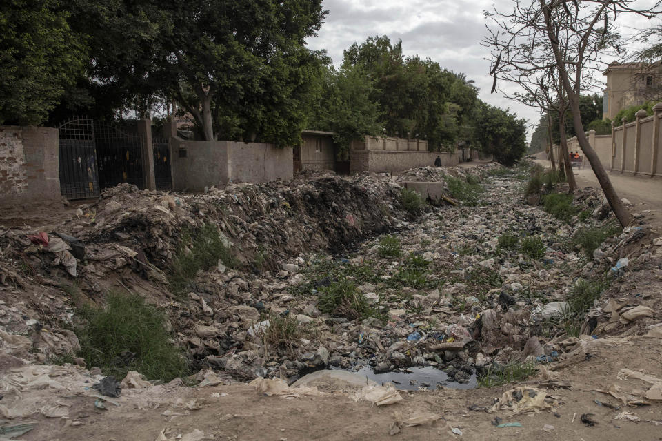 Trash fills a water canal in an impoverished area where people have been greatly affected by the coronavirus outbreak, in Cairo, Egypt, Thursday, April 9, 2020. (AP Photo/Nariman El-Mofty)