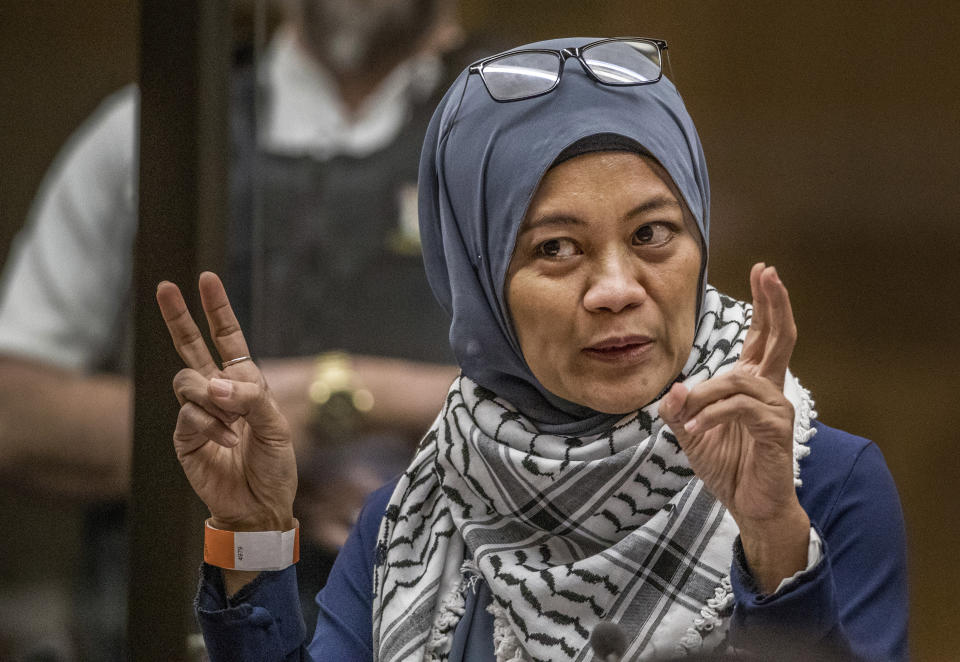 Hamimah Tuyan gestures as she gives her victim impact statement during the sentencing hearing for Australian Brenton Harrison Tarrant at the Christchurch High Court after Tarrant pleaded guilty to 51 counts of murder, 40 counts of attempted murder and one count of terrorism in Christchurch, New Zealand, Wednesday, Aug. 26, 2020. More than 60 survivors and family members will confront the New Zealand mosque gunman this week when he appears in court to be sentenced for his crimes in the worst atrocity in the nation's modern history. (John Kirk-Anderson/Pool Photo via AP)