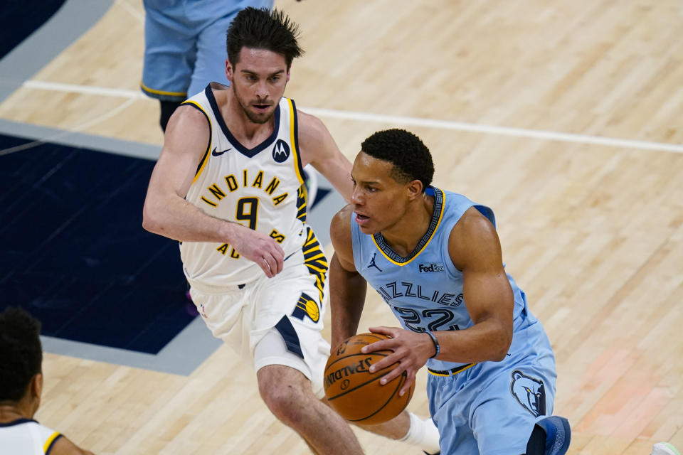 Memphis Grizzlies guard Desmond Bane (22) drives on Indiana Pacers guard T.J. McConnell (9) during the first half of an NBA basketball game in Indianapolis, Tuesday, Feb. 2, 2021. (AP Photo/Michael Conroy)