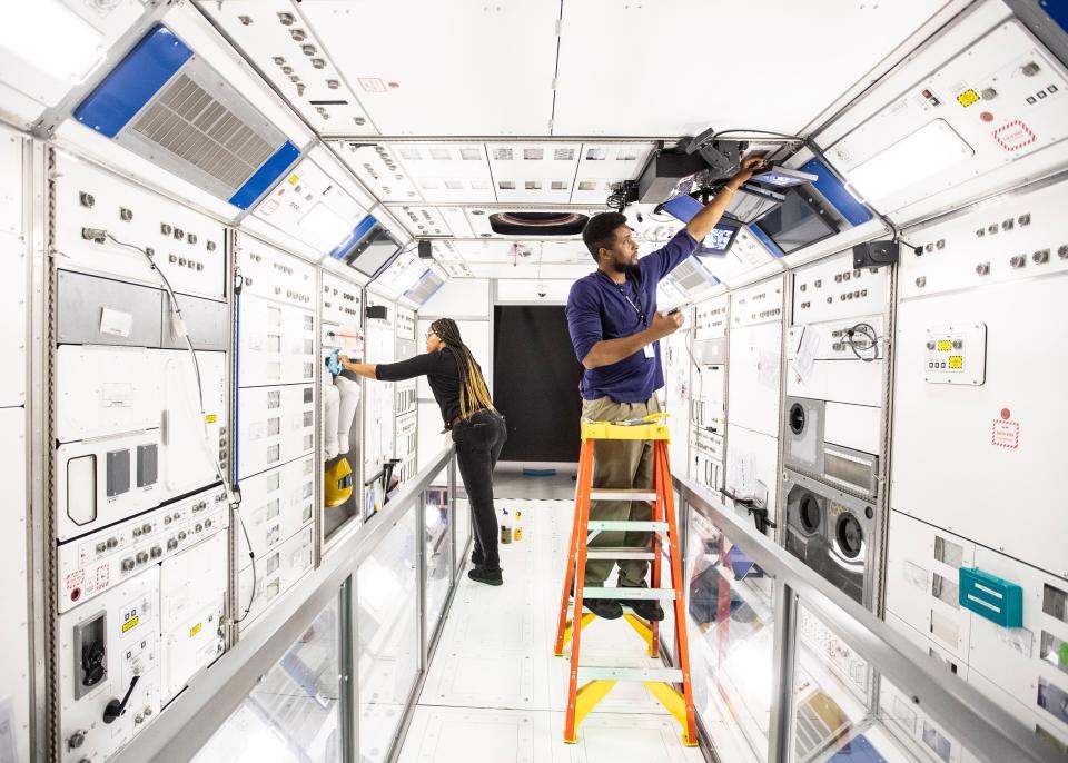 Archivists Dewana Oliver and Brian Johnson set up the 
full-size walk-in replica of the U.S Destiny lab aboard the International Space Station. The labs will be the centerpiece in Graceland's 10,000-square-foot space exhibit 