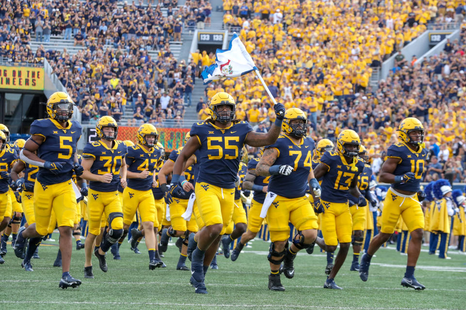 MORGANTOWN, WV - OCTOBER 02: West Virginia Mountaineers defensive lineman Dante Stills (55) leads the Mountaineers on to the field prior to the college football game between the Texas Tech Red Raiders and the West Virginia Mountaineers on October 2, 2021, at Mountaineer Field at Milan Puskar Stadium in Morgantown, WV. (Photo by Frank Jansky/Icon Sportswire via Getty Images)