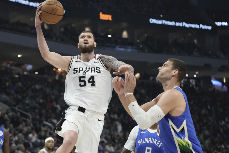 San Antonio Spurs' Sandro Mamukelashvili shoots past Milwaukee Bucks' Brook Lopez during the first half of an NBA basketball game Wednesday, March 22, 2023, in Milwaukee. (AP Photo/Morry Gash)