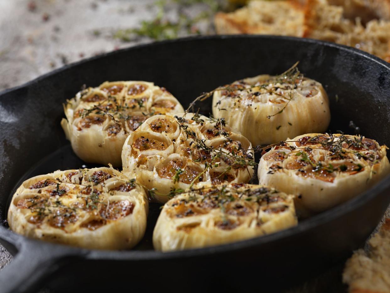 Roasted Garlic with Salt, Pepper, Thyme and Olive Oil in a Cast Iron Skillet