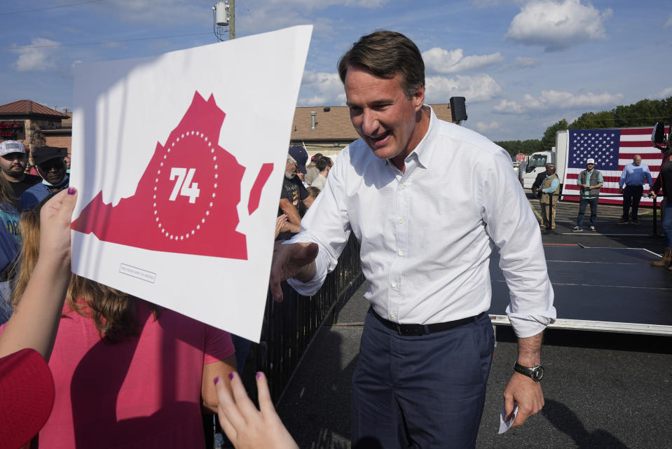 FILE - Virginia Gov. Glenn Youngkin greets supporters during an early voting rally, Sept. 21, 2023, in Petersburg, Va. Youngkin had made clear his expectations for last week's closely watched legislative elections were a GOP majority in the House and Senate. Instead, Democrats have taken both. (AP Photo/Steve Helber, File)