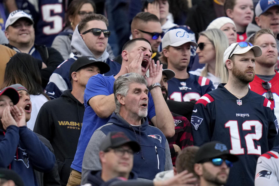 New England Patriots fans react after Patriots quarterback Mac Jones threw an interception in the final minute of an NFL football game against the Washington Commanders, Sunday, Nov. 5, 2023, in Foxborough, Mass. (AP Photo/Charles Krupa)