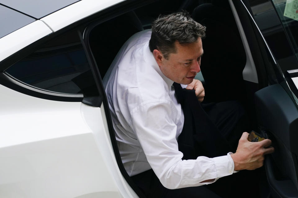 Elon Musk arrives at the justice center in Wilmington, Del., Tuesday, July 13, 2021. Musk took to a witness stand Monday to defend his company's 2016 acquisition of a troubled company called SolarCity against a shareholder lawsuit that claims he's to blame for a deal that was rife with conflicts of interest and never delivered the profits he had promised. (AP Photo/Matt Rourke)