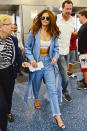 <p>The pop star sensation looked to Marques' Almeida for a tailored menswear take on classic denim. She breezed through airport security in Miami rocking an ab-baring bralette and slim-fit jeans styled with a matching frayed duster and simple sandals.</p>