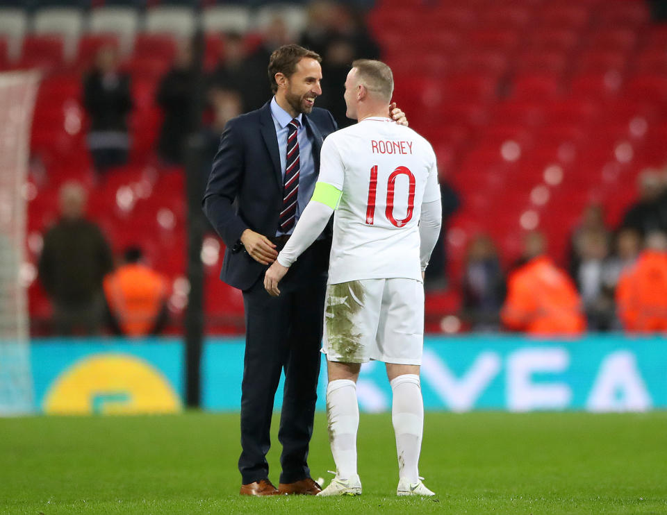 England manager Gareth Southgate shakes hands with Rooney (Nick Potts/PA)