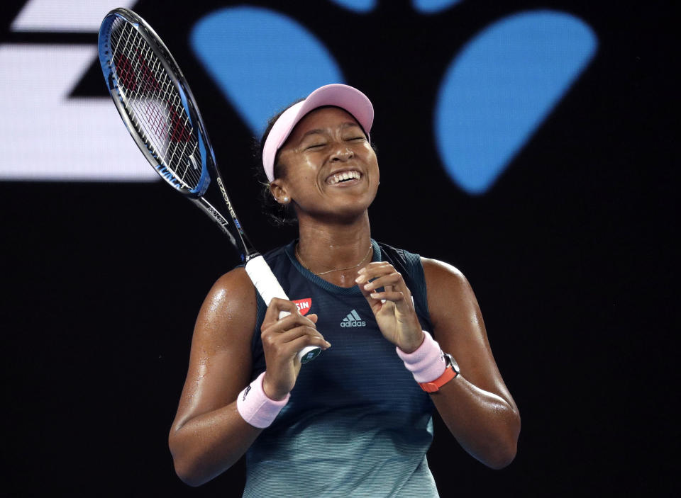 Japan's Naomi Osaka smiles during her first round match against Poland's Magda Linette at the Australian Open tennis championships in Melbourne, Australia, Tuesday, Jan. 15, 2019. (AP Photo/Kin Cheung)
