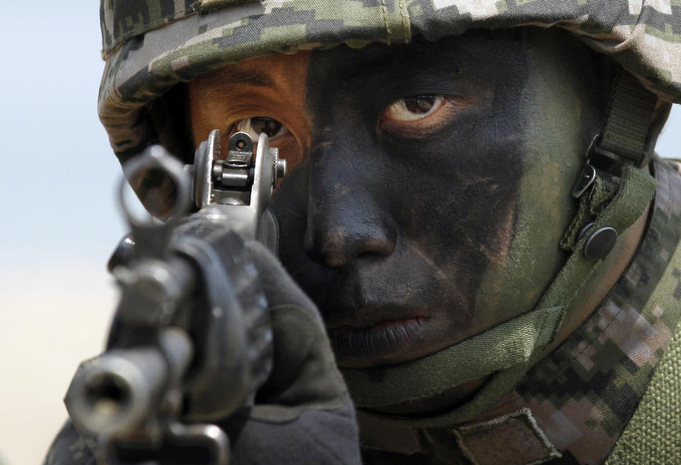 FILE - In this April 26, 2013 file photo, a South Korean Marine takes position during the joint military exercises between South Korea and the United States called Ssangyong 2013 as a part of annual Foal Eagle military exercises in Pohang, south of Seoul, South Korea. North Korea’s propaganda machine is churning out near-daily diatribes against the United States and South Korea for a series of soon-to-start military maneuvers, warning nuclear war could be imminent and saying it will take dramatic action of its own if further provoked. (AP Photo/Kin Cheung, FIle)