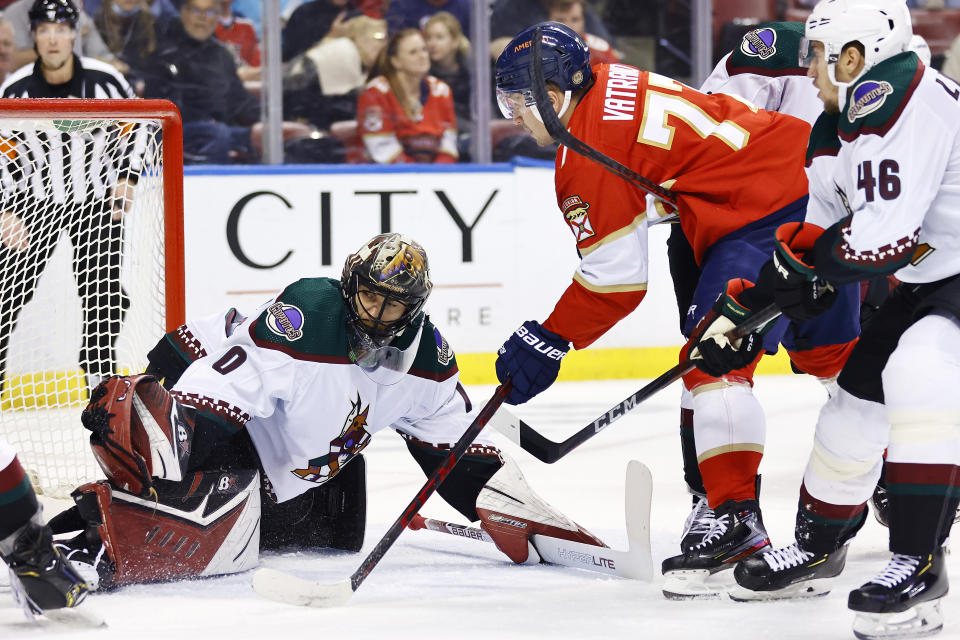 Florida Panthers left wing Frank Vatrano (77) scores a goal past Arizona Coyotes goaltender Karel Vejmelka (70) during the second period of an NHL hockey game, Monday, Oct. 25, 2021, in Sunrise, Fla. (AP Photo/Michael Reaves)