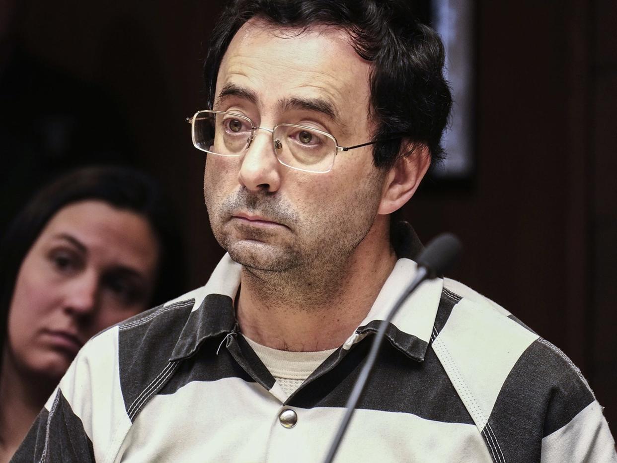 Dr. Larry Nassar listens to testimony of a witness during a preliminary hearing, in Lansing, Mich., Friday, Feb. 17, 2017. Three former elite U.S. gymnasts have come forward saying they were sexually abused by Nassar, a former doctor facing trial on another matter.