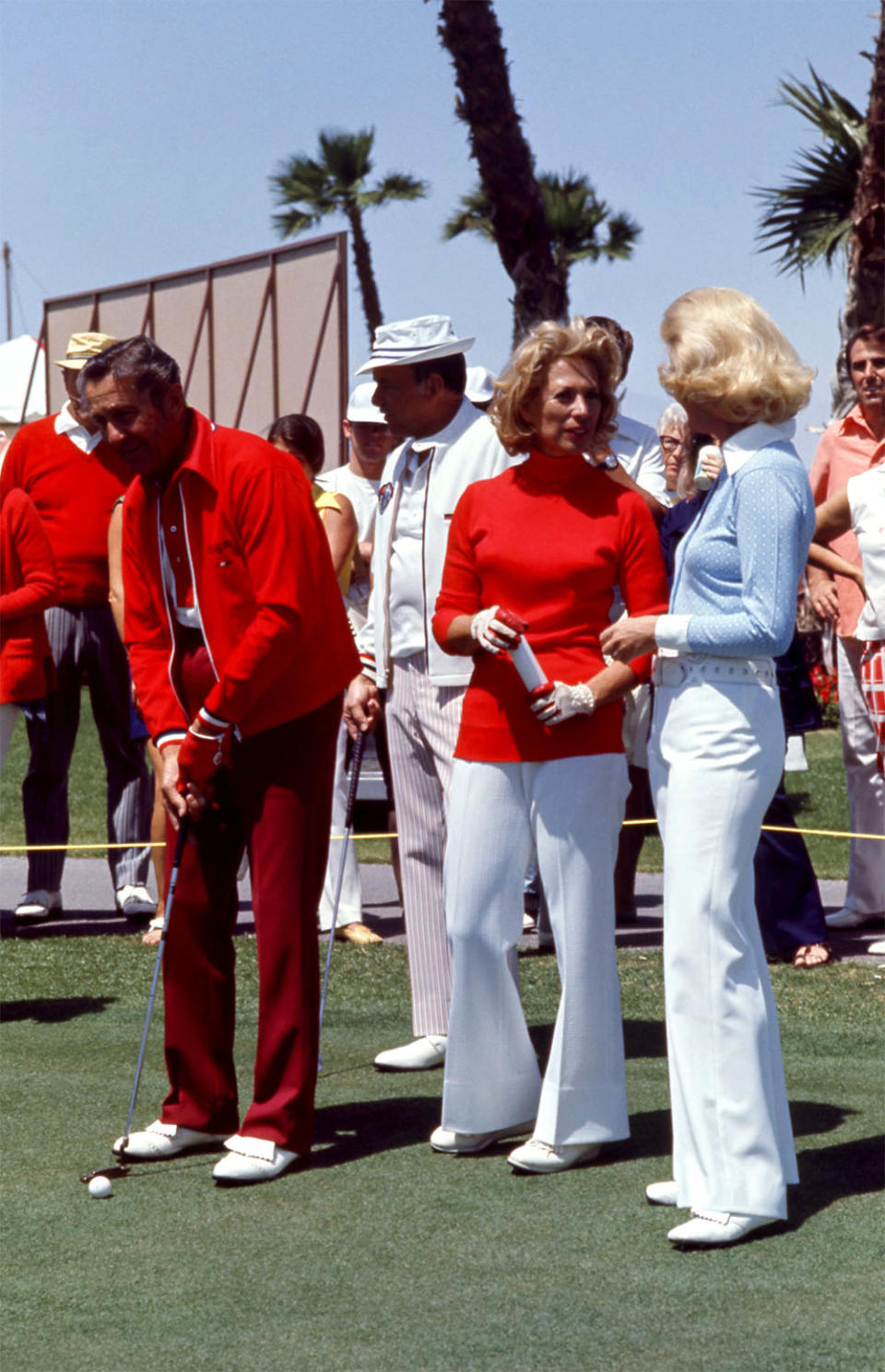 American musician Lawrence Welk putts as American singer Frank Sinatra, American singer Dinah Shore and American model Barbara Sinatra look on during the 1972 Dinah Shore Colgate Winner's Circle on April 16, 1972 at the Mission Hills Country Club in Rancho Mirage, California.