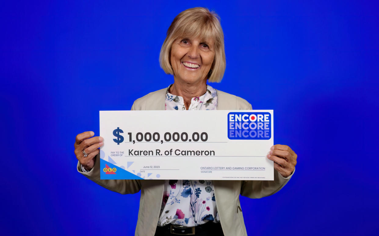 Woman holding a $1 million lotto ticket. 