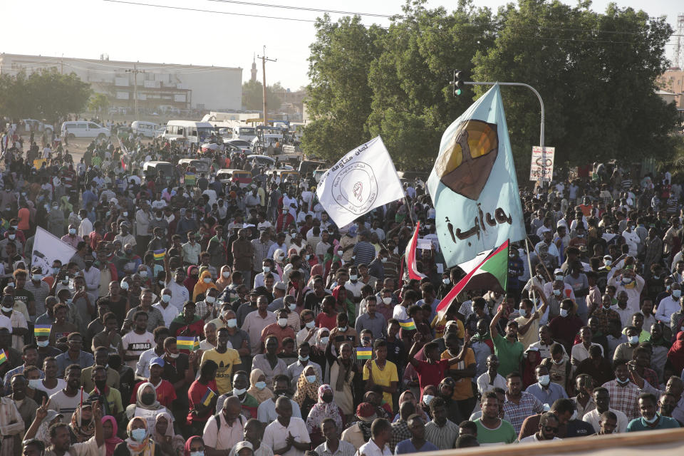 Thousands of protesters take to the streets to renew their demand for a civilian government in the Sudanese capital Khartoum, Thursday, Nov. 25, 2021. The rallies came just days after the military signed a power-sharing deal with the prime minister, after releasing him from house arrest and reinstating him as head of government. The deal came almost a month after the generals orchestrated a coup. Sudan's key pro-democracy groups and political parties have dismissed the deal as falling short of their demands for a fully civilian rule. (AP Photo/Marwan Ali)