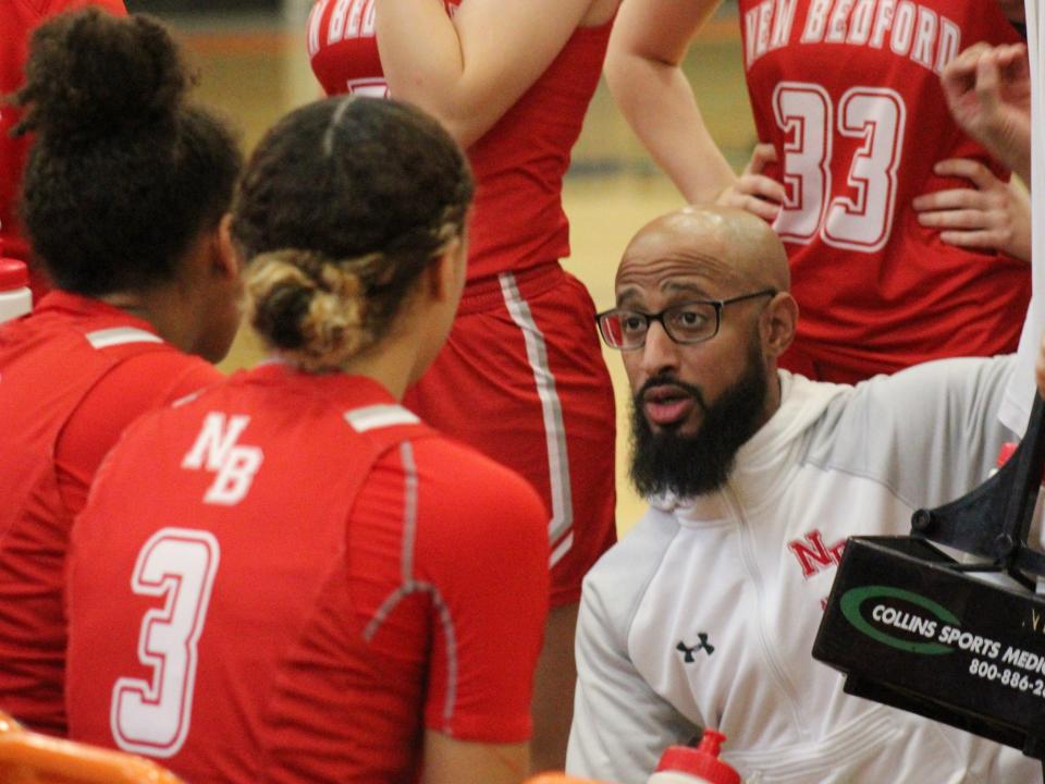 New Bedford coach Jordan Pina speaks with his team during a timeout in a non-league game against Taunton.