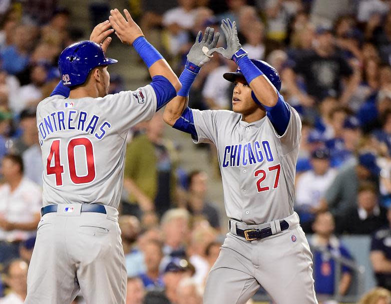 Addison Russell of the Cubs celebrates his two-run homer with Willson Contreras. (Getty)