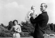 <p>Baby Prince Charles being lifted up by his father The Duke of Edinburgh in 1949 (PA) </p>