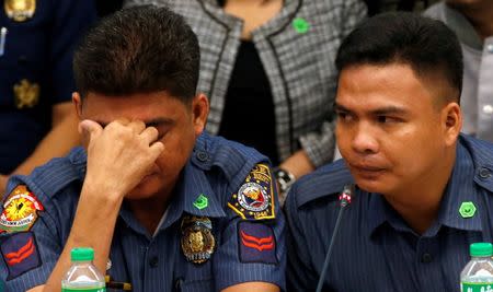 Policemen accused by a woman of killing a couple who she says are her parents, alleged by police as drug pushers during an illegal drugs "meth" raid, testify at a Senate hearing in Pasay, Metro Manila, Philippines August 23, 2016. REUTERS/Erik De Castro