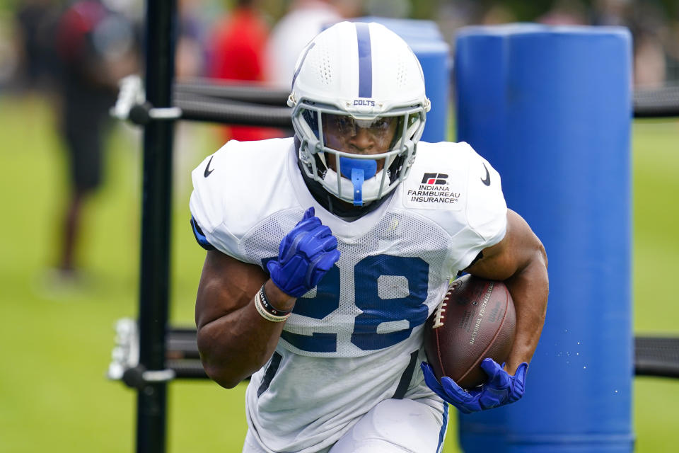 Indianapolis Colts running back Jonathan Taylor (28) runs a drill during practice at the NFL team's football training camp in Westfield, Ind., Tuesday, Aug. 2, 2022. (AP Photo/Michael Conroy)