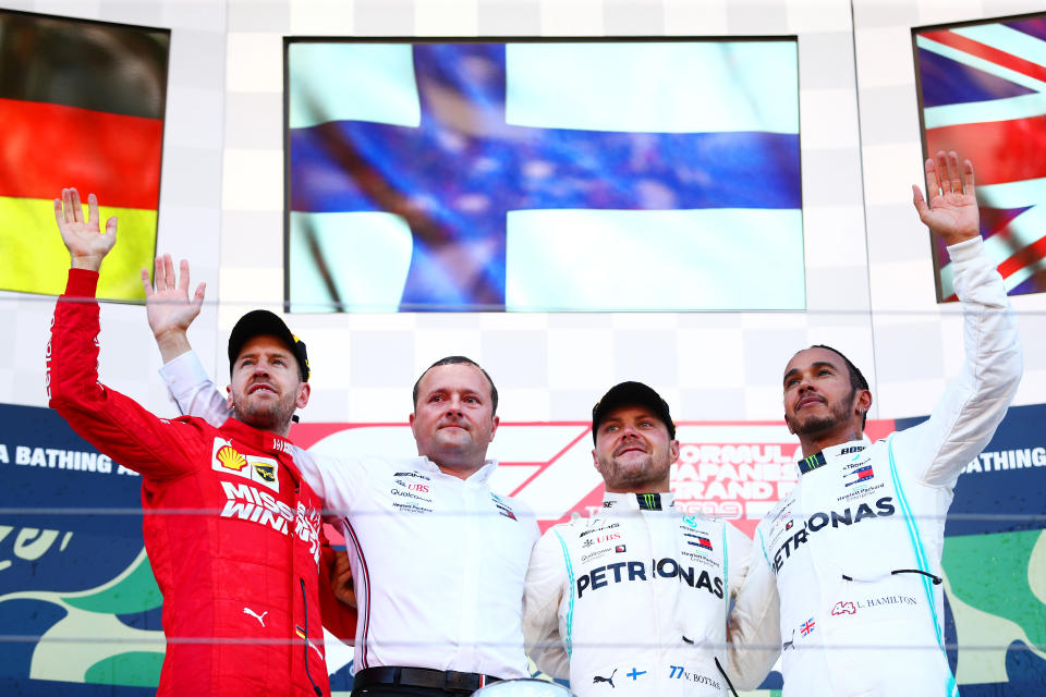 SUZUKA, JAPAN - OCTOBER 13: Top three finishers Valtteri Bottas of Finland and Mercedes GP, Sebastian Vettel of Germany and Ferrari and Lewis Hamilton of Great Britain and Mercedes GP celebrate on the podium during the F1 Grand Prix of Japan at Suzuka Circuit on October 13, 2019 in Suzuka, Japan. (Photo by Dan Istitene/Getty Images)