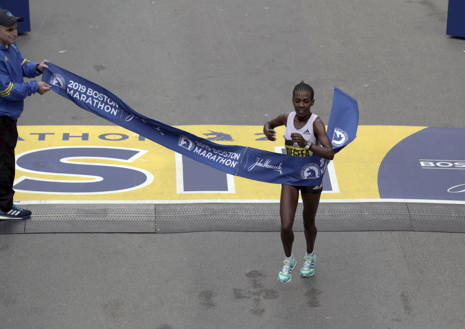 Worknesh Degefa, of Ethiopia, breaks the tape to win the women's division of the 123rd Boston Marathon on Monday, April 15, 2019, in Boston. (AP Photo/Charles Krupa)