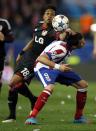 Atletico Madrid's Mario Mandzukic (R) and Bayer Leverkusen's Wendell fight for the ball during their Champions League round of 16 second leg soccer match at Vicente Calderon stadium in Madrid March 17, 2015. REUTERS/Sergio Perez (SPAIN - Tags: SPORT SOCCER)