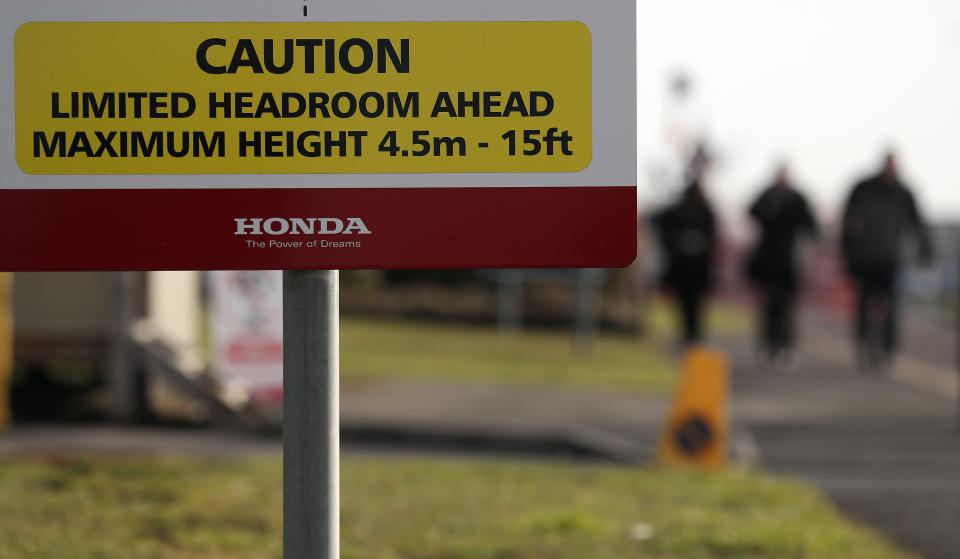 Employees leave the Honda car plant in Swindon, western England, Tuesday, Feb. 19, 2019. The Japanese carmaker Honda announced Tuesday that its Swindon car plant will close with the potential loss of some 3,500 jobs. (AP Photo/Frank Augstein)