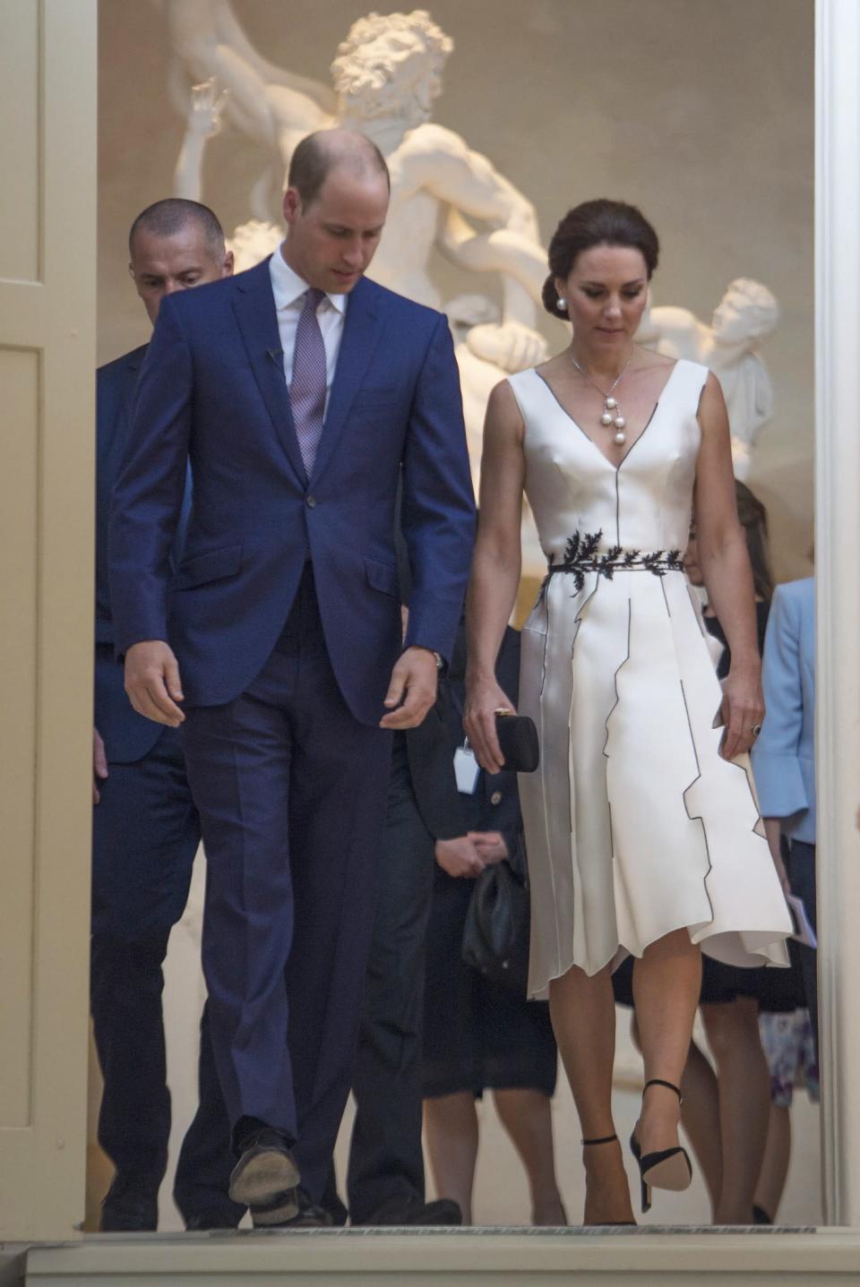 <p>Kate dressed diplomatically for an evening event in Poland, turning to Polish designer <span>Gosia Baczynska. The designer, who’s well known within Poland, created a monochrome, satin number for the Duchess complete with embroidered waistline. <br><em>[Photo: PA]</em><br></span> </p>
